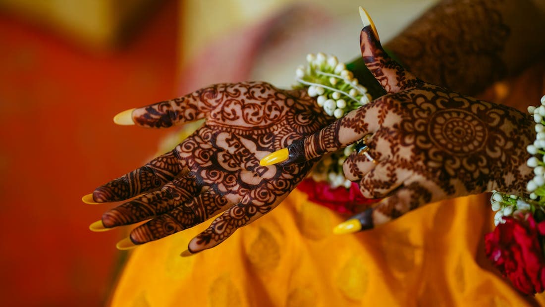 Intricate mehndi henna designs on a bride hands