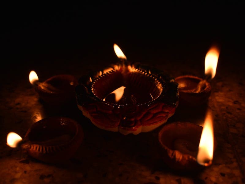Traditional Diwali oil lamps glowing in the dark